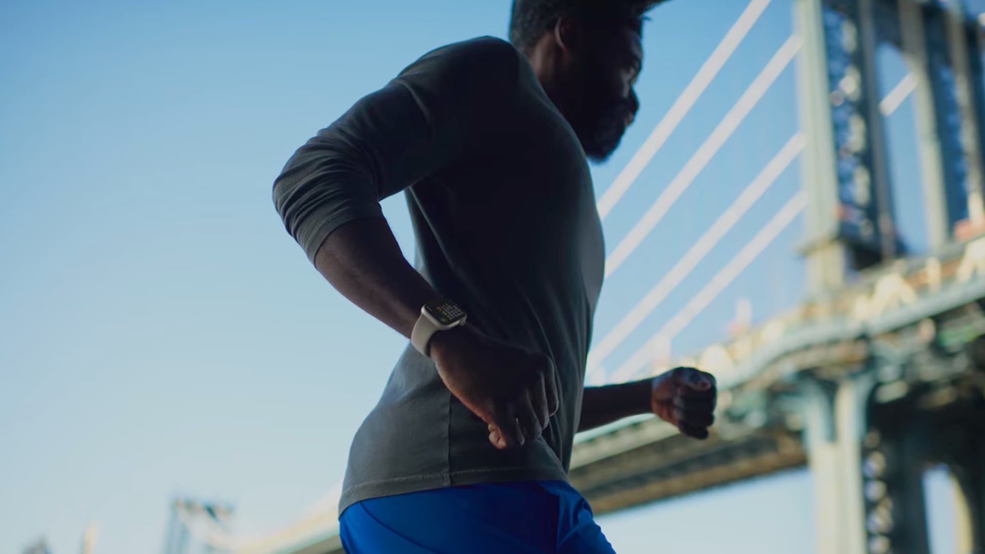 Black athlete jogging outside while wearing his Apple Watch